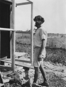 'Raymond the carpenter', barefoot, stands outside a building under construction at Whiteway.